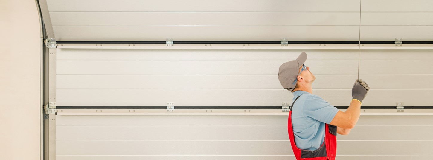 A repairman fixing a garage door